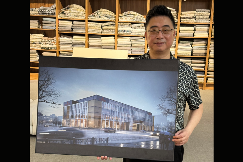 Phillip You, Kelida owner, shows off rendering of new factory in Hangzhou.